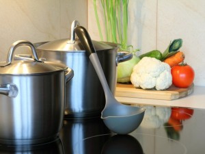 healthy soup with vegetables in the kitchen , pot on induction hob