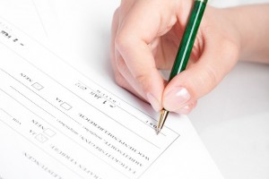 Female hand signing contract.