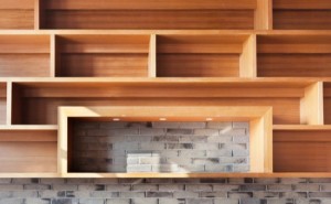Empty wood shelf on brick wall