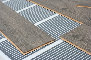 Infrared floor heating system under laminate floor