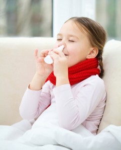 Little girl spraying her nose