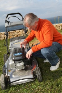 Senior man mowing the lawn
